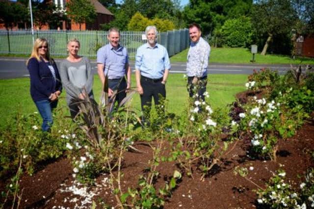 Admiring the flower beds are June McRoberts and Lyndsay Graham, of Castlemara Community Association, with Colin Baker and Ronnie 
McCreanor, of the Housing Executive grounds team, and Barry Craig, landscape architect with the Landscape Centre. INCT 30-752-CON