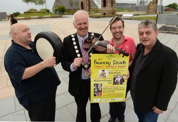Lord Mayor of Dungannon & South Tyrone Borough Council, Cllr Roger Burton, offically launches the Brantry Fleadh 2014 under the watchful eye of Cathal Hayden, Fiddle player with the Mairtin O'Connor Trio and Fleadh compere Gino Lupari from the group Four Men and a Dog. Pic L to R Gino Lupari, Lord Mayor Cllr Roger Burton, Mark Mohan, Fleadh organisor and Cathal Hayden