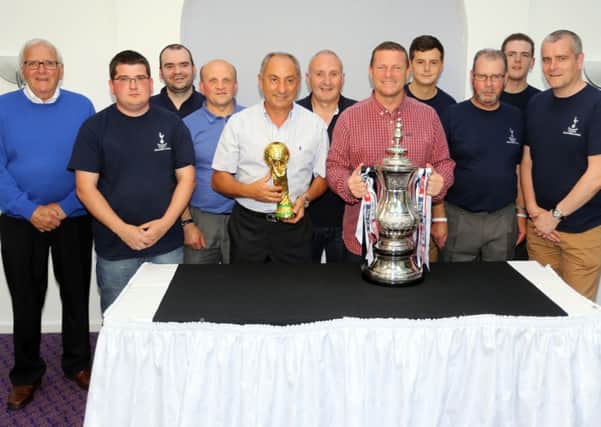 Spurs legends Ossie Ardiles and Micky Hazzard with members of the Ballymena Spurs Supporters Club. INBT30-231AC