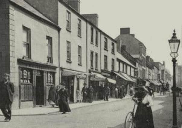 Upper Mill Street in the early days of the 20th century. The two ladies with their wonderful dresses and hats are standing outside the site of the modern day 'George Buttery'.