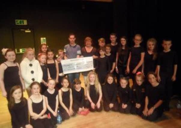 Moyraverty Arts and Drama Society Committee members Niall Devlin and Laura Corr who helped to get the society £5600 from BBC Children in Need with some of the Mads Members who will benefit from the award.