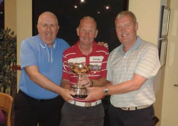 Joe Connor and Maurice Ferguson, winners of the Fred Oldham Foursomes, received the trophy from Andy Sproule, Dunmurry GC Hon Secretary.