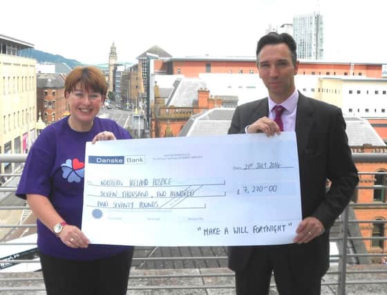 Richard Palmer, President of The Law Society, hands over a cheque for £7,270 to Sharon Gorman, NI Hospice Donor Officer.