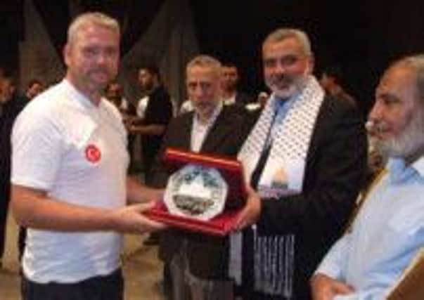Palestinian President Ismail Haniyah alongside senior officials in Gaza present Councillor Padraig McShane with a plaque in recognition of the Humanitarian efforts of the people of Moyle in 2010. inbm31-14 s