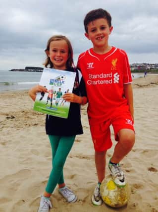 Ben and Rebecca Andrews from County Antrim with the first copy of the Dale Farm Milk Cup programme which is now on sale. (S)
