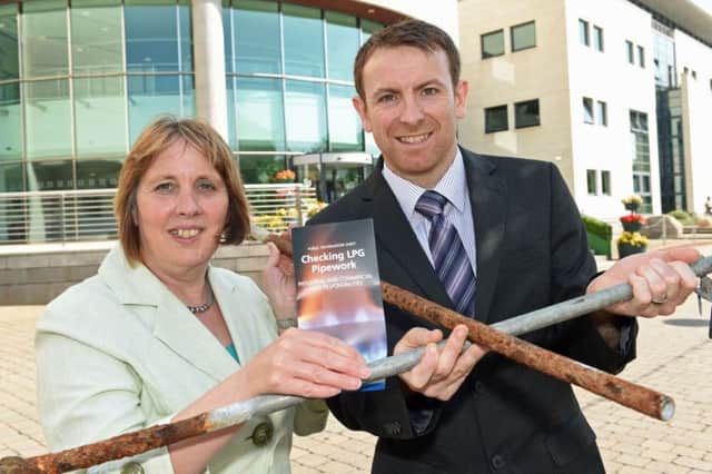 Councillor Jenny Palmer, Chair of the Council's Environmental Services Committee and Mr Barry Rooney, Partnership Liaison Officer,Local Authority Unit, HSENI demonstrate how LPG underground metallic pipework can corrode and allow Liquid Petroleum Gas to escape. The Council is working in partnership with the Health and Safety Executive NI to promote the dangers with local businesses that use tanked gas.