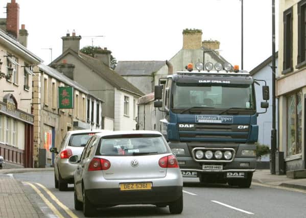 Traffic passing through the bottom of Main Street in Dungiven. LV43-719MML