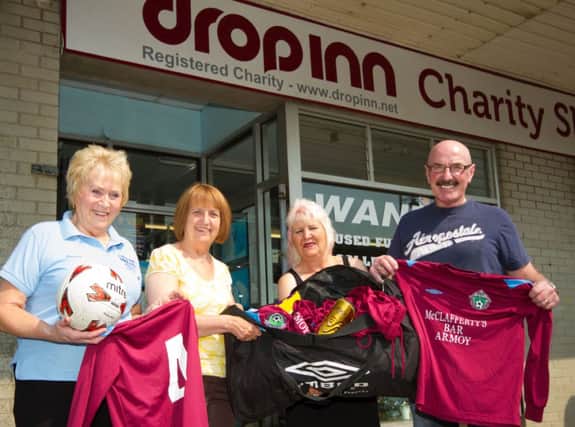 GET STRIPPED. Pictured is Liam Beckett handing over two full football kits for children to Edwina Chambers, Jennifer Gilmour and Anne Knox of Drop Inn Ministries  Ballymoney. The kits are being sent to boys and girls in Burkino Faso, Africa.INBM31-14 026SC.