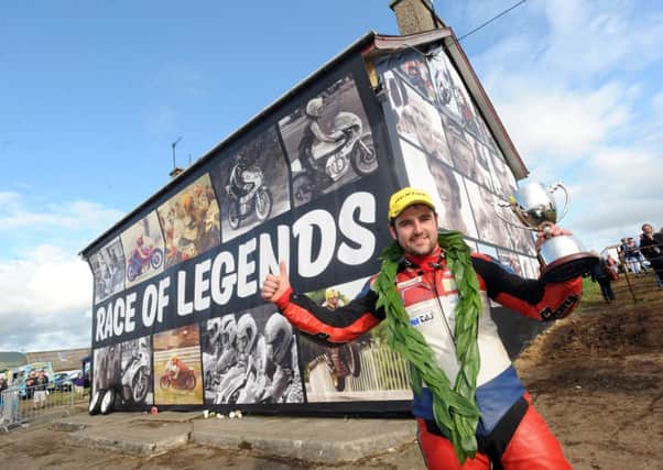 PACEMAKER, BELFAST, 26/7/2014:  Michael Dunlop (Hawk BMW) celebrates after winning the Race of Legends at Armoy road races. The organisers decorated this derelict house in the paddock with images of the Armoy Armada and past and current riders at the Co Antrim event. 
PICTURE BY STEPHEN DAVISON