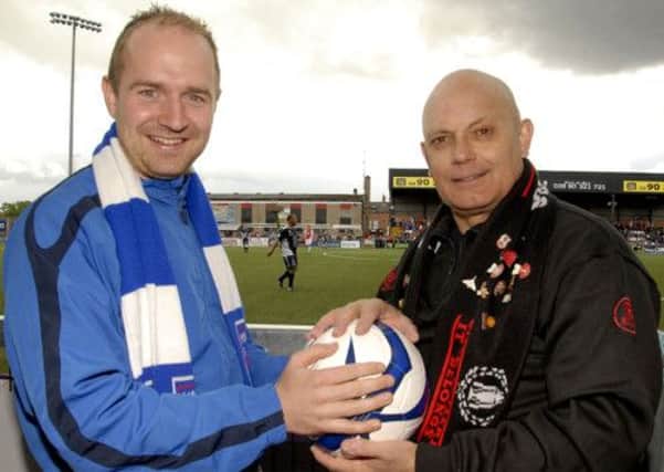 ITS MINE.....Moneyslane First Team Captain, Gareth Bingham, tussles with former Manchester United mid-field player Ray Wilkins, who will be one of a host of galaxy Manchester United Legend players, who will play Moneyslane Football Club Select, during a exhibition match at the Grand Opening of the new club complex at Jubilee Park, Moneyslane, on Saturday.  Photo: Gary Gardiner.
