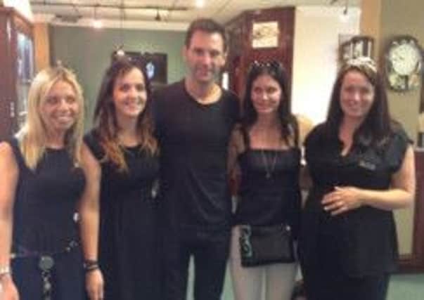 Courtney Cox and Johnny McDaid, who visited Cooley's with Ms Cox's daughter Coco pictured with staff members