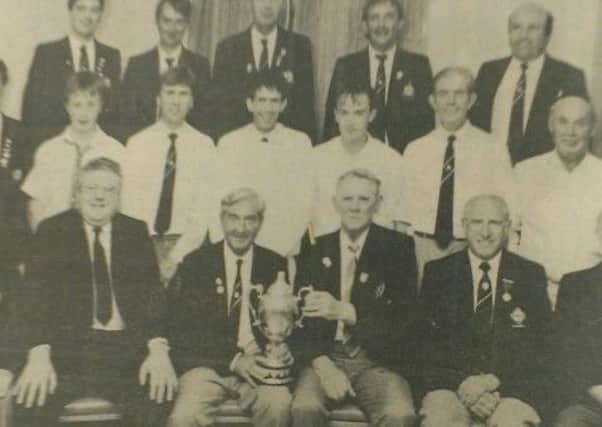 Members of Cookstown Bowling Club with the Piggot Cup won 25 years ago when they beat Coleraine in the final at Limavady Recreation Grounds.