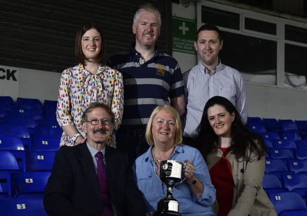 Milk Cup chairman Victor Leonard with Norma McClarty and the David McClarty Fair Play Trophy. Included are Alan and Colin McClarty, Colin's wife Niamh and Claire Sugden (seated, right), East Londonderry Independent Assembly member. (S)