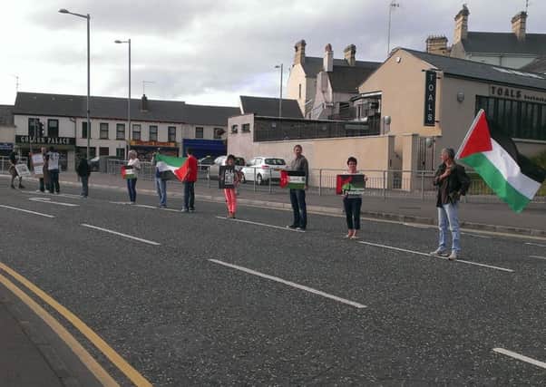 Some of those taking part in a White Line Picket on Millennium Way, Lurgan in support of the people of Gaza