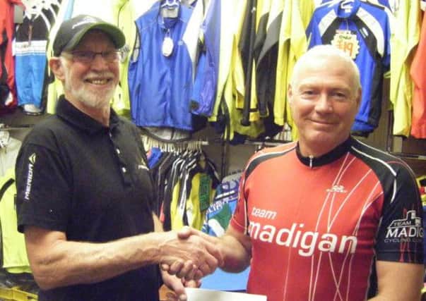 Ronnie McKeegan of Madigan Cycles Carrickfergus (left) presents Team Madigan Secretary Davy Ross with a sponsorship cheque for the Madigan Cycles Grand Prix.