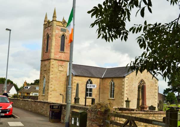 Tricolour beside Church of Ireland in Dungiven