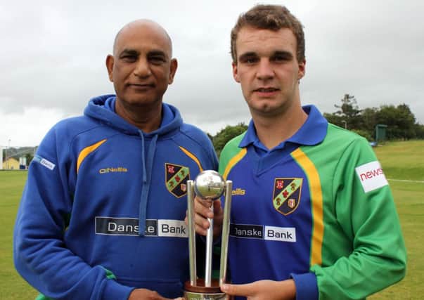 North West Warriors skipper Andrew McBrine (right) and coach Bobby Rao holding the Newstalk Inter-Provincial T20 Trophy.
