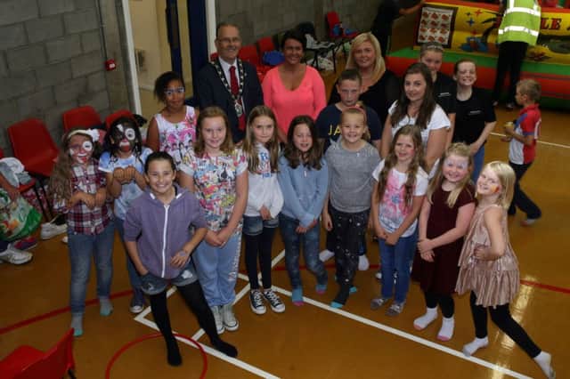 Some of the children at the Neillsbrook summer scheme pictured with the Mayor of Antrim, Cllr. Brian Graham who visited the group last week. INAT32-402AC