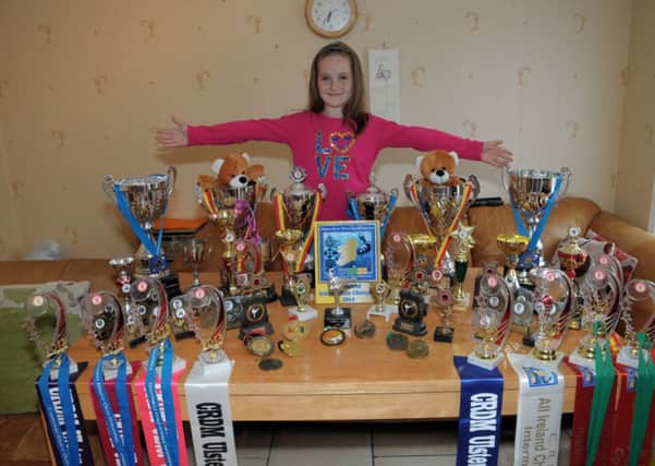 Amy McCambridge All Ireland Champion in the 8yrs. group shows off her trophies she has won in Irish Dancing and Karate, Amy dances with Royal Tara Dance Academy and fights for Larne Karate Club  INLT 33-217-AM