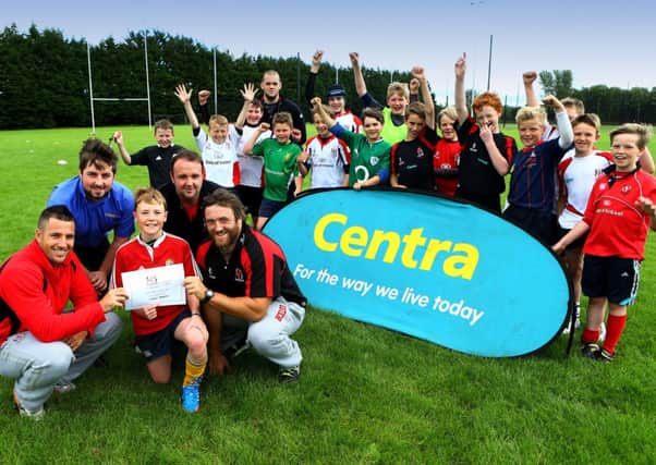 Ulster Rugby Players Ian Humphreys and Dave Ryan present the Best Skills Award to Calum Stevenson, with Adam McLean from Centra Shellhill, on hand to represent camp sponsor, Centra, and Shaun Bloomfield (Camp Manager) Calum is cheered on by other camp participants. (s)