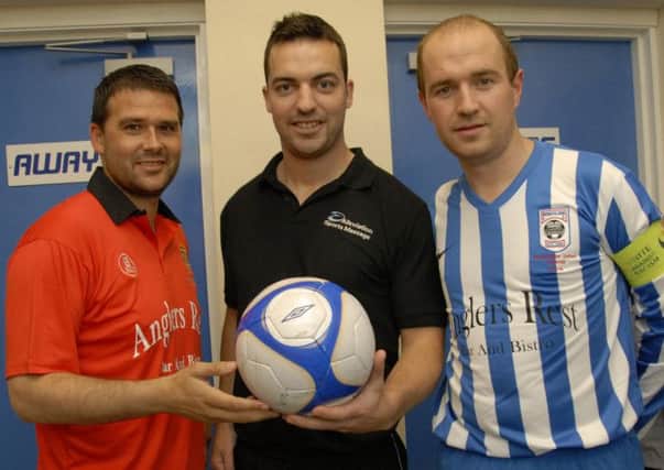 Manchester United Legend David Healy, receives a Matchball presentation from sponsor Stephen Patterson, Aleviation Sports Massage. Looking on is Gareth Bingham, Moneyslane FC Select Captain.   © Photo; Gary Gardiner. IN BL WK 3214-502.
