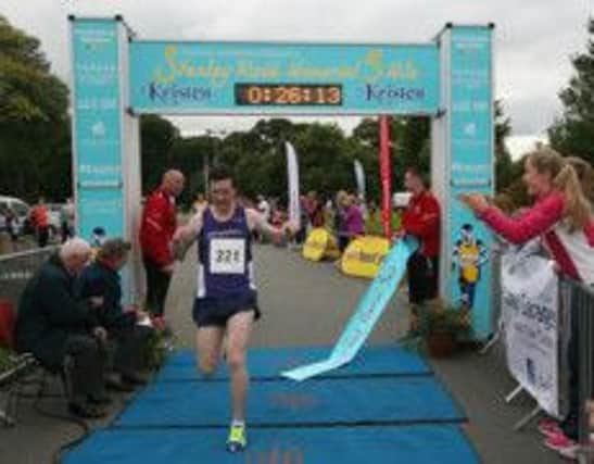 Neil Johnson breaks the tape to win the 'Stanley Reid Memorial' 5 Mile Road Race in Cookstown. (picture courtesy of Event Stands)