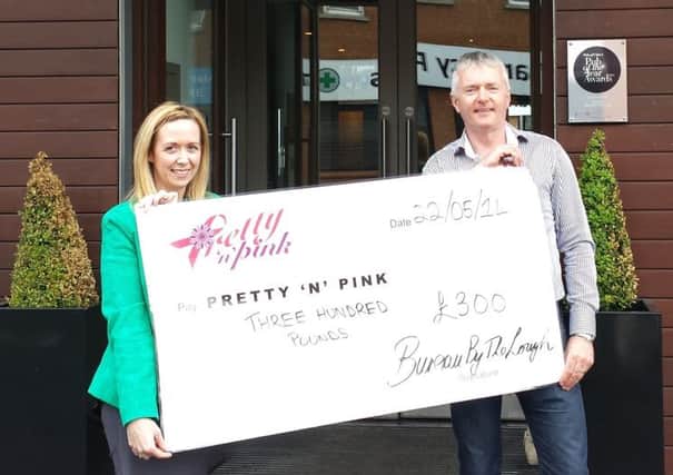 Damien Curran from Bureau By The Lough hands over the cheque for £300 to Noeleen McErlane from Pretty n Pink. INNT 25-453-CON
