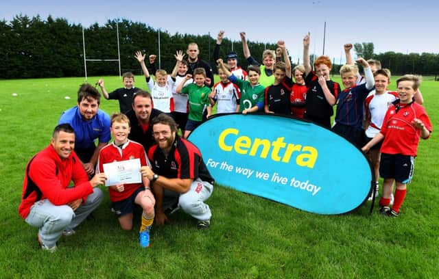 Ulster Rugby Players Ian Humphreys and Dave Ryan present the Best Skills Award to Calum Stevenson, with Adam McLean from Centra Shellhill, on hand to represent camp sponsor, Centra, and Shaun Bloomfield (Camp Manager) Calum is cheered on by other camp participants. (s)