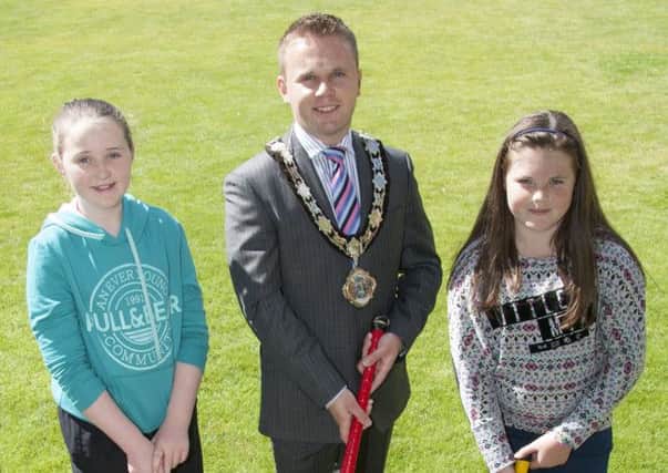 Looking forward to the upcoming hockey week in Ballyclare are Katie Leonard (left) and Maddison Wilson, pictured with Mayor of Newtownabbey Alderman Thomas Hogg.