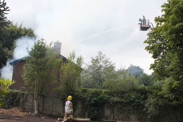 Fire crew damping down a house fire on the Mountsandel Road in Coleraine on Thursdsay afternoon. Picture: Mark Jamieson