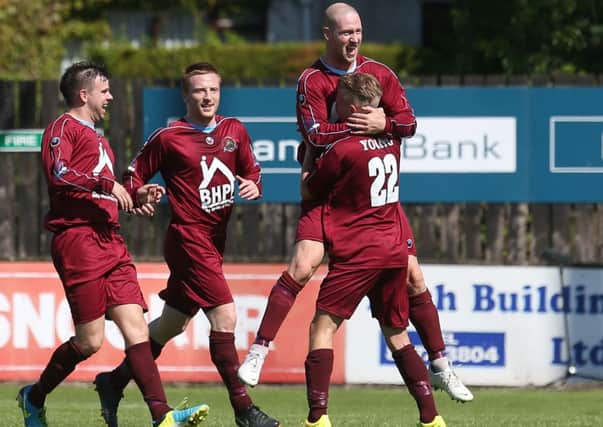 Institute's Stephen O'Flynn celebrates with Matthew Young (22), Thomas McBride and Dwayne McManus after he fired home their opener at Dungannon Swifts. Picture by Matt Mackey/Presseye.com