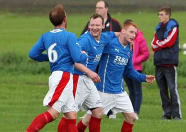 Jonny Spence (right) is congratulated after scoring by Carniny Rangers team mates Leslie McCaughern and Stephen Green. INBT33-221AC