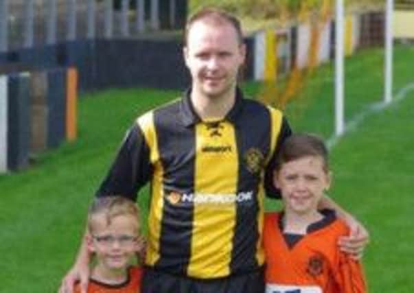 Carrick striker Graeme Arthur pictured with sons Charlie (left and Jamie after Saturday's 2-0 win over Donegal Celtic.