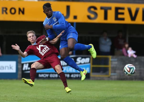 Institute's Matty Young tackles Dungannon Swifts Abiola Sanusi during Saturday's match. Picture by Matt Mackey/PressEye