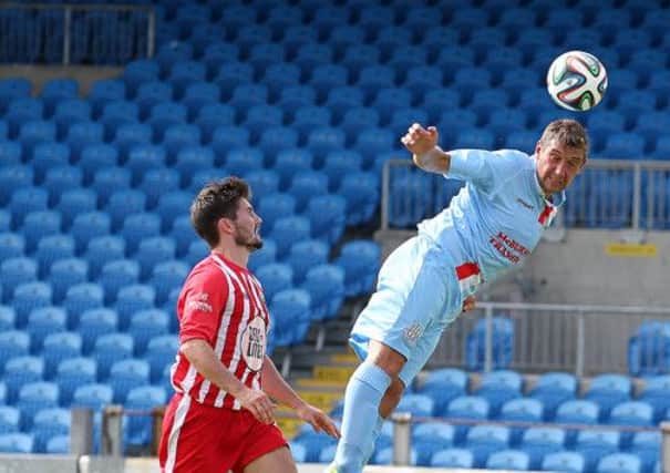 Ballymena United striker Matthew Tipton stretches to win a header during Saturday's win over Warrenpoint Town. Picture: Press Eye.