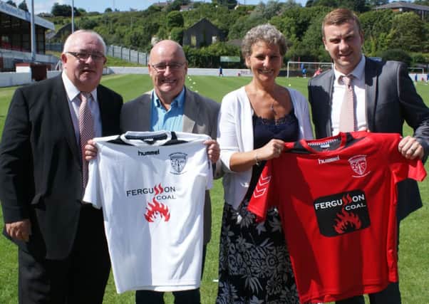 Stephen Ashe and Betty Wilson from Fergusson Coal present Larne FC chairman Archie Smyth and first-team manager David McAlinden with the club's new home and away shirts.