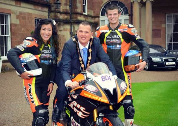 The Mayor of Lisburn, Councillor Andrew Ewing is pictured with Patricia Fernandez and Timmy Elwood of racing team 'Magic Bullet' at Hillsborough Castle.
