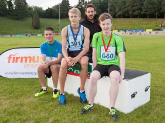 Pictured with Paul Nugent of firmus energy are Scott McDowell (centre) from Lagan Valley Athletic Club who was placed first in the Boys Under 15 100 metres and Matthew Wilson (right) from Orchard County Athletic Club and Josh Armstrong from City of Lisburn Athletic Club who came second and third respectively.