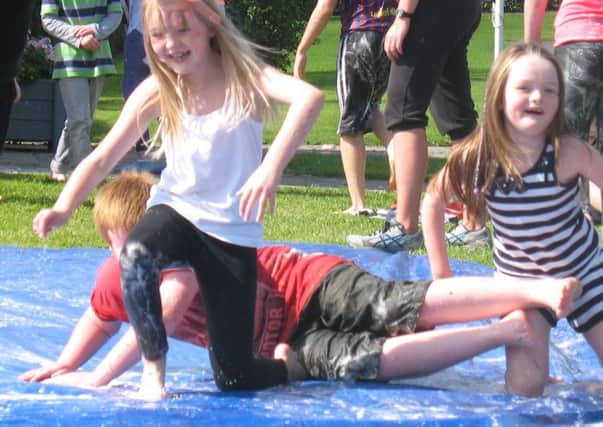 Having fun in soap suds and water at the YMCA play day at Dixon Park. INLT 34-659-CON