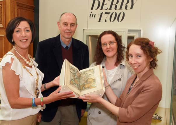 Frank Reynolds, sub-Librarian for the facility of the University of Ulster and Fionnuala Carlin, art Librarian, handing over two books on loan from the University, on the Ulster Plantation, to the citys Mayor Councillor Brenda Stevenson and Bernadette Walsh,  Archivist with Derry City Council. 3214-9822MT.