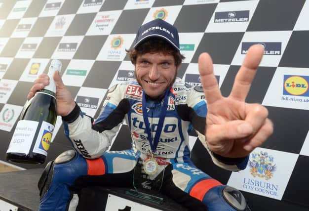 Guy Martin celebrates his victory in the Dundrod 150 Superbike race at the Metzeler Ulster Grand Prix on Thursday