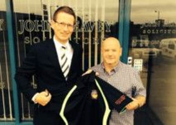 David Kernoghan of Reavey and Co. presents Percy McCord (chairman of Whitehouse Working Men's Club) with new sponsored shirts for the forthcoming season. INLT 33-902-CON