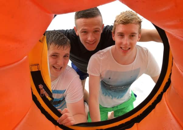 Christopher Barnaby, Dylan McCallion and Andrew Graham inside the zorbing ball at a recent Youth Forum day out at Oakfire Adventures.