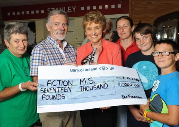 Des Keenan presents a cheque for £17,000, proceeds from his Cooker Push to Ann Walker, Action MS chief executive and MS volunteers Kyra Fields, Ann Fields Jack Chambers and Josh Chambers.