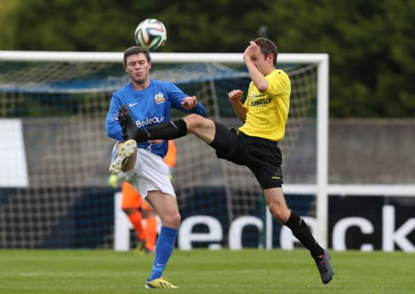 Kevin Braniff of Glenavon and David McCullough of Dungannon battle for the ball.