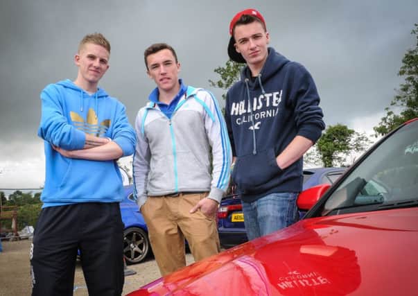 Richard Callum, Nathan Johnston and Jacob Sweeney viewing some of the impressive array of vehicles on display at the NI Cruise Show and Shine held at the grounds of Mid Ulster Auctions, Castledawson in aid of Project Romania.