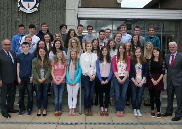 Students from Ballymena Academy who got three A's or better in their A Level exams are pictured with Mr. Ronnie Hassard (retiring principal) and Mr. Stephen Black (incoming principal). INBT34-218AC