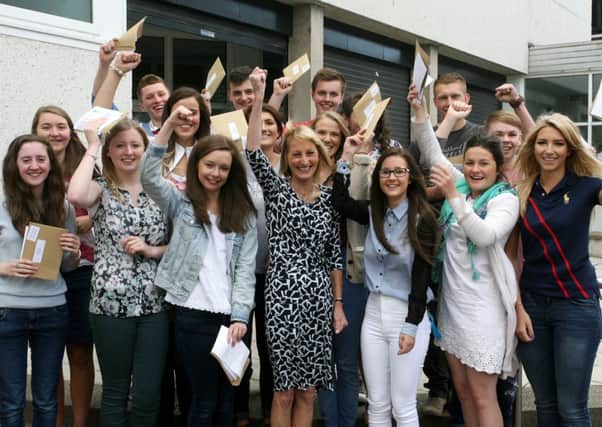 Mrs. E. Lutton with students from Cambridge House celebrating their A level results. INBT34-205AC