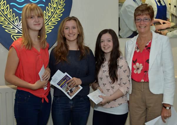 A and AS Level students Hayley Jebb, Kerry McClenaghan and Lisa Wilson with Ballyclare Secondary School principal Kathryn Bell. INNT 35-005-PSB