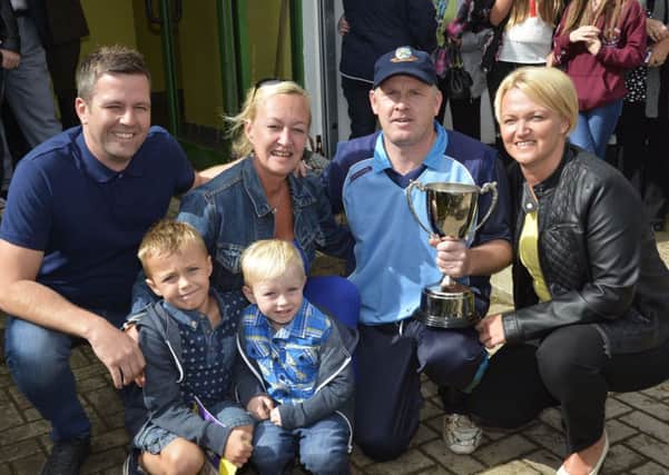 Glendermott captain Gordon Montgomery, pictured with family members of the late Eric Cooke, from left, Dan, Zach, Max and Wendy Penney, and Tracey Cooke, who presented the Eric Cooke Memorial Cup at the North West T20 finals at the Bleechgreen on Sunday. INLS3314-135KM